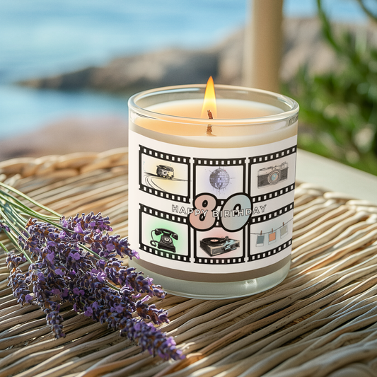 Candle with a 'Happy Birthday' '80' -theme on a woven surface near lavender and ocean view