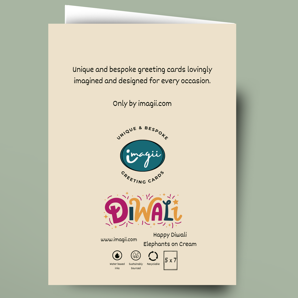 A cream-colored greeting card shown against a muted sage green background. The card features black descriptive text at the top, the 'imagii' logo in the center, and a colorful 'Diwali' title with 'Happy Diwali Elephants on Cream' at the bottom.