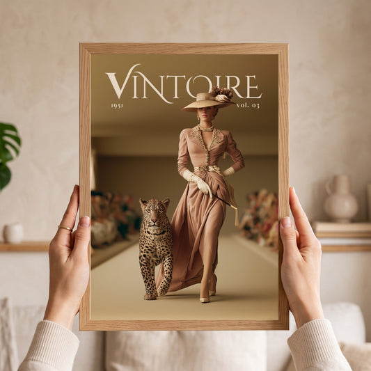 A person holds a framed art print featuring a vintage fashion magazine cover titled 'VINTOIRE 1951 vol. 03'.