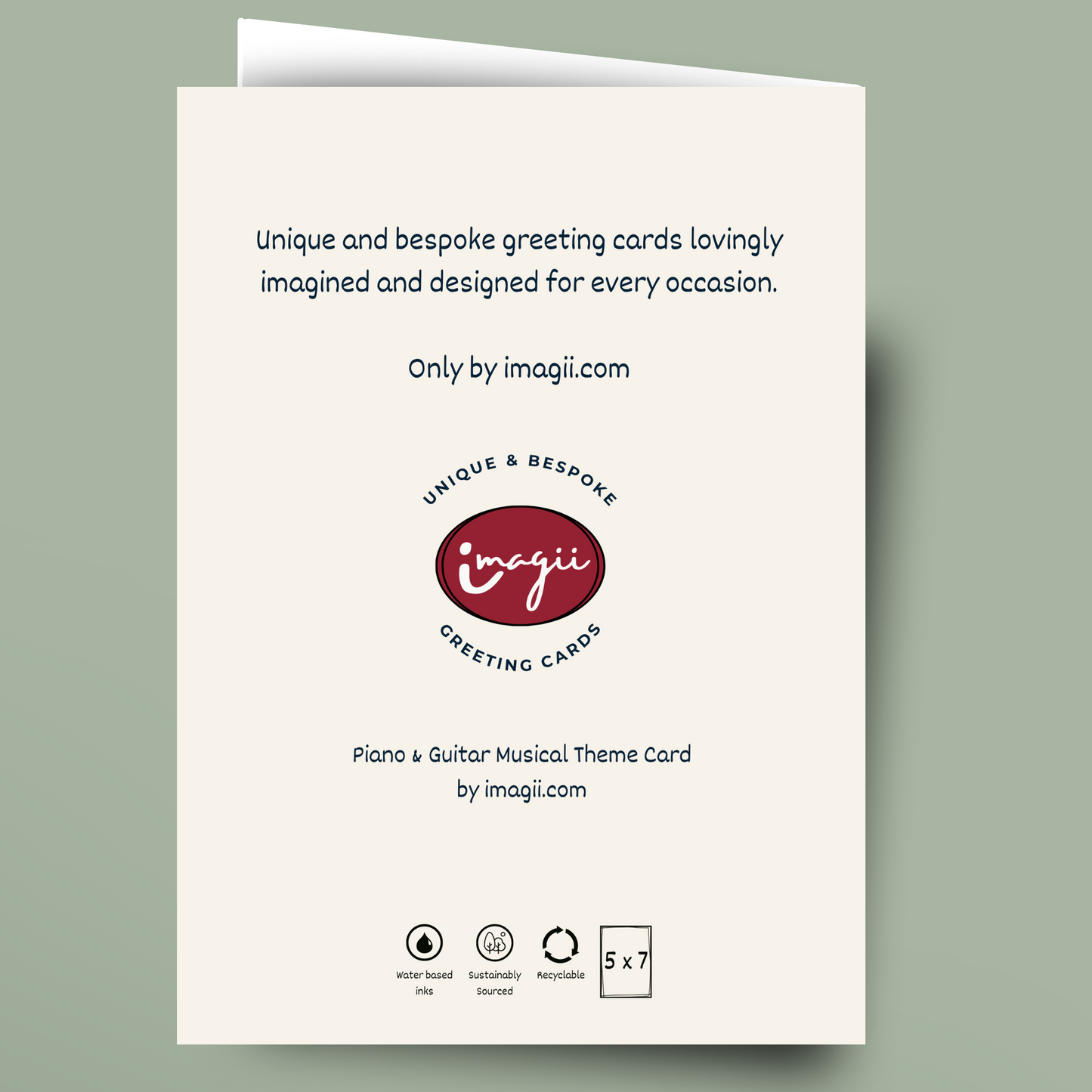 A folded greeting card shown against a muted sage green background. The card is off-white with black text and a central red oval logo reading 'imagii greeting cards'.
