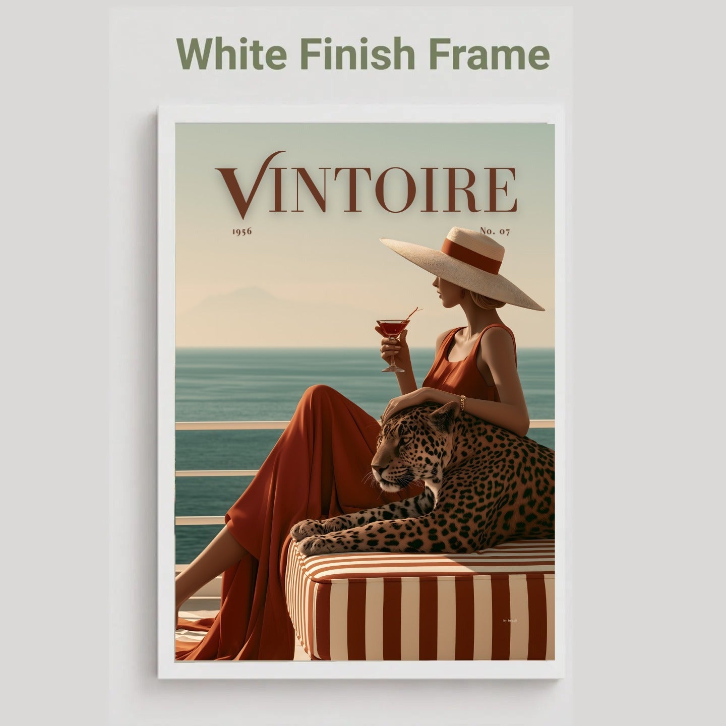 White framed Framed poster of a faux magazine cover featuring a woman holding a cocktail with a leopard by the ocean, featuring the title 'Vintoire'.