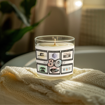 Candle with a 'Happy Birthday' '80' -themed label on a white surface with a plant in the background