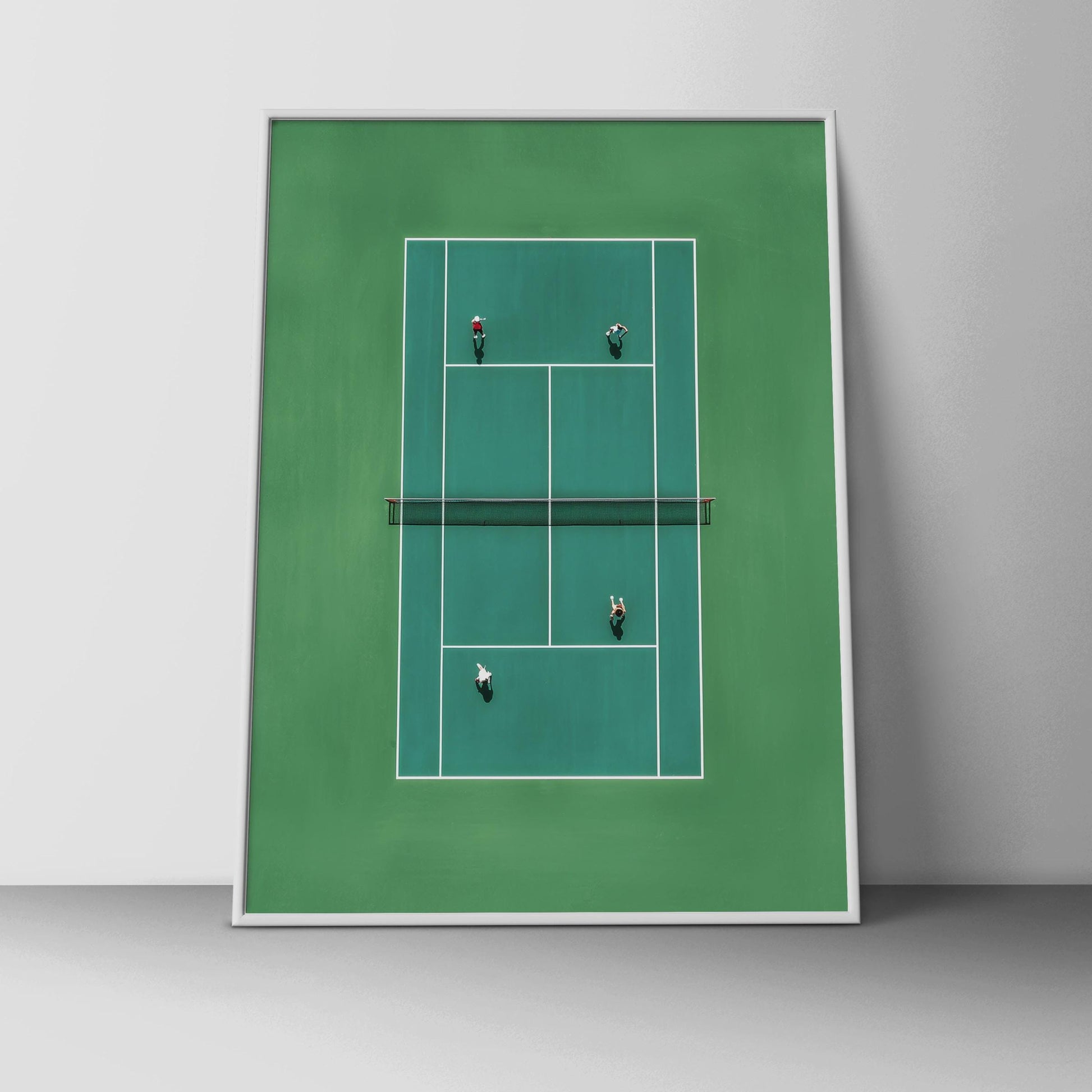 Framed artwork of a tennis court with players on a white wall.