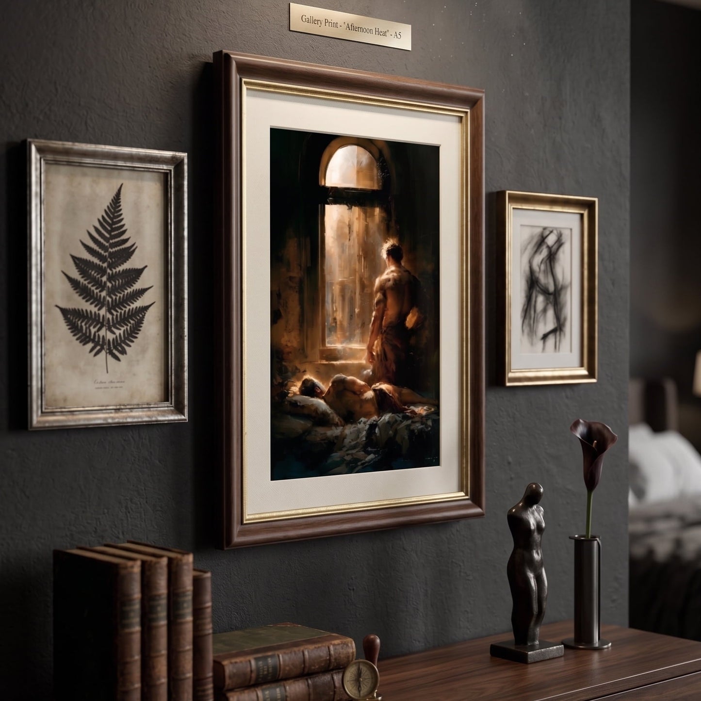 A framed art print depicting a classical scene of a figure by a window, styled on a dark gray wall above a wooden console table with books and sculptures.