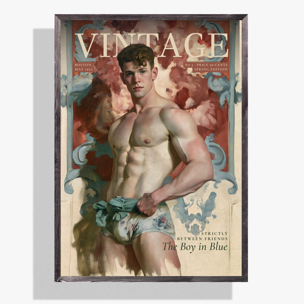 A framed vintage-style poster or print featuring a muscular male model with the large word 'VINTAGE' across the top and additional text including 'The Boy in Blue'. The artwork has a cream background with red, blue, and flesh-toned imagery, and the piece is shown hanging against a light gray wall.