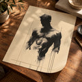 A black ink figure drawing of a muscular male torso on cream-colored paper, displayed on a rustic wooden desk with a potted plant, a book, and a bowl nearby.