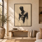 Bare Masculinity male figure print in a black frame on a warm cream wall above a rustic wooden bench, with a jute rug, olive tree and large vase.