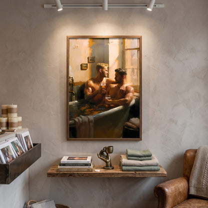A framed art print depicting two men in a bathtub scene, displayed on a textured plaster wall in a styled room setting with a wooden shelf, books, and a leather armchair.