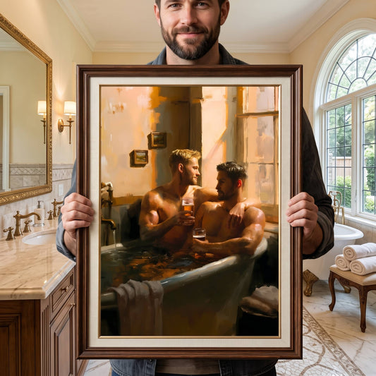A man in a bathroom holds up a large framed painting depicting two men relaxing in a bathtub and sharing a drink. The painting is enclosed in a dark brown wooden frame with a cream mat.