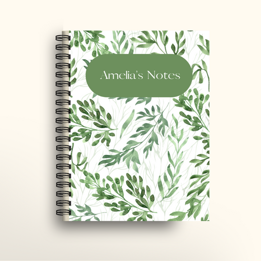Notebook with green leaf pattern and 'Amelia's Notes' label on a white background