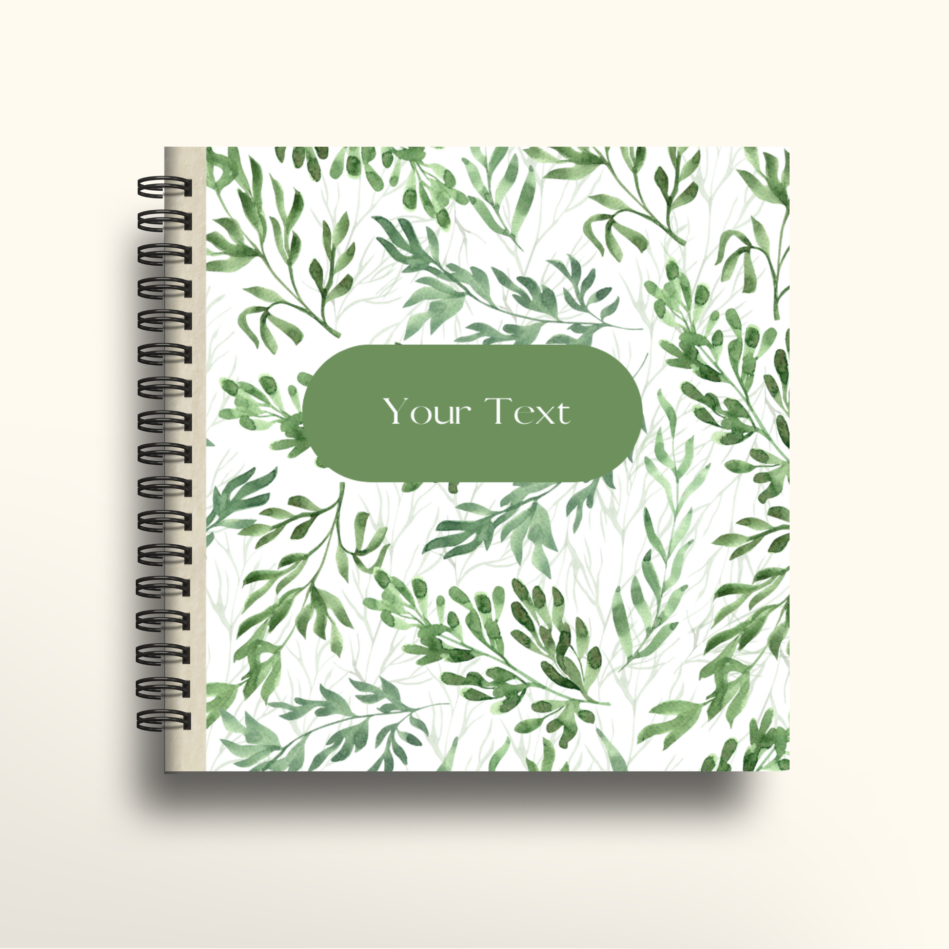 Notebook with green leaf pattern and customizable text area on a white background