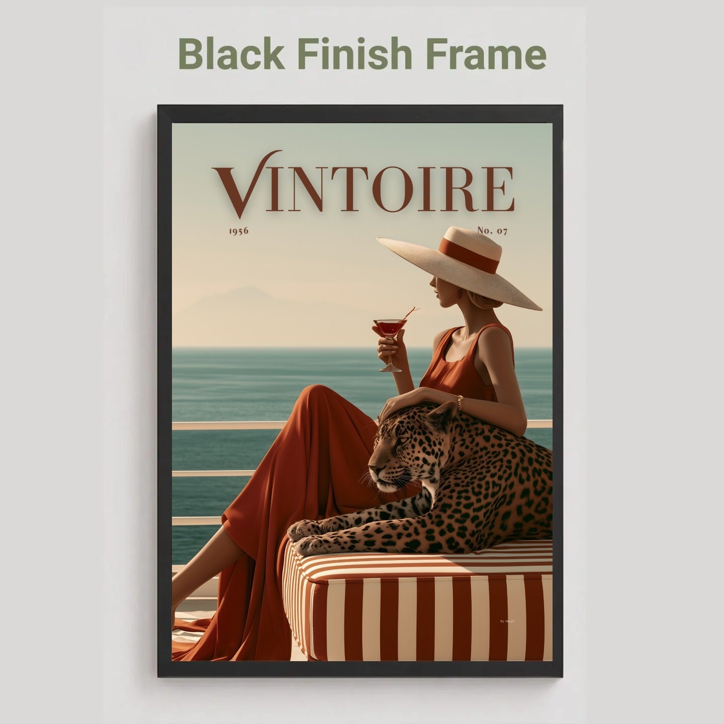 Black framed poster of a faux magazine cover featuring a woman holding a cocktail with a leopard by the ocean, featuring the title 'Vintoire'.
