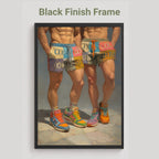 A framed art print featuring a painting of two cropped male figures from the waist down wearing colorful shorts and sneakers, displayed against a light gray background with the text 'Black Finish Frame' above it.