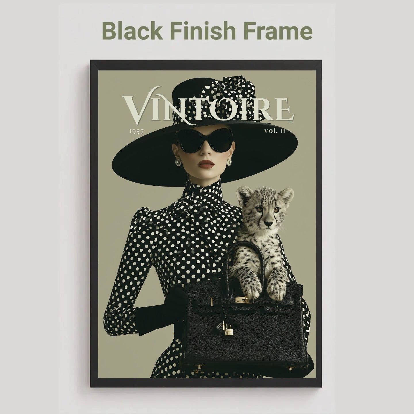 A framed art print featuring a vintage-style fashion illustration with the text 'Black Finish Frame' above it. The artwork shows a woman in a black wide-brim hat and black-and-white polka dot dress holding a small spotted kitten over a black handbag, with the magazine-style title 'VINTOIRE' across the top.