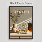A framed art print featuring a minimalist Martini still life with a martini glass, bowls of snacks, and a vase with leaves, presented in a black finish frame against a light gray background with the text 'Black Finish Frame' above it.