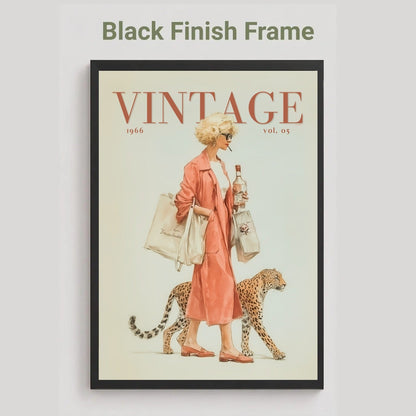 A framed vintage-style poster on a light gray background, with the text 'Black Finish Frame' above it. The poster shows a woman in a pink coat walking with a leopard, with the word 'VINTAGE' at the top and '1966 vol.