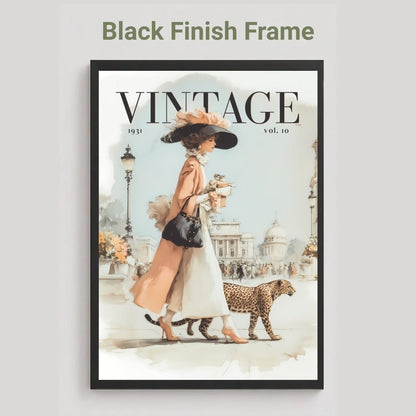 A framed vintage-style art print featuring a woman in a peach dress and black hat walking with a leopard, with the word VINTAGE at the top. The frame is black, and the image is shown against a light gray background with the text 'Black Finish Frame' above.