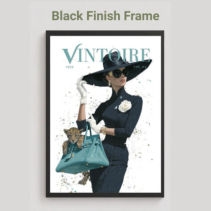 A framed art print featuring a vintage-style magazine cover illustration with the title 'VINTOIRE' and the text 'Black Finish Frame' above it. The artwork shows a woman in a black outfit and wide-brim hat holding a teal handbag with a leopard cub, set against a light background.