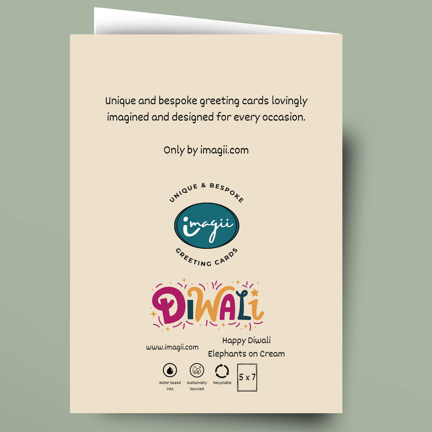 A cream-colored greeting card shown against a muted sage green background. The card features black descriptive text at the top, the 'imagii' logo in the center, and a colorful 'Diwali' title with 'Happy Diwali Elephants on Cream' at the bottom.