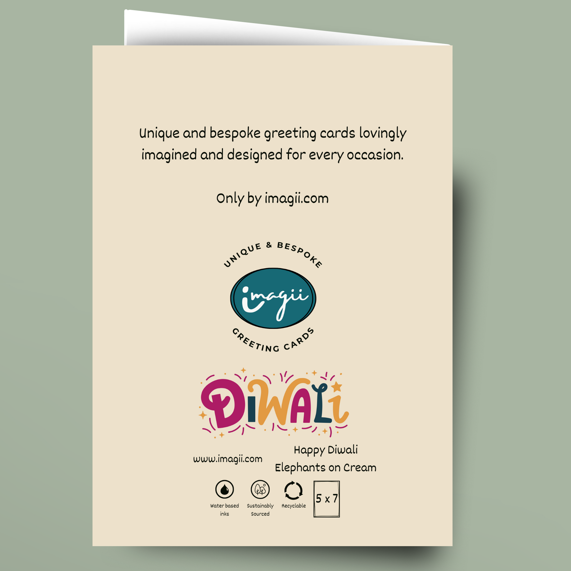 A cream-colored greeting card shown against a muted sage green background. The card features black descriptive text at the top, the 'imagii' logo in the center, and a colorful 'Diwali' title with 'Happy Diwali Elephants on Cream' at the bottom.