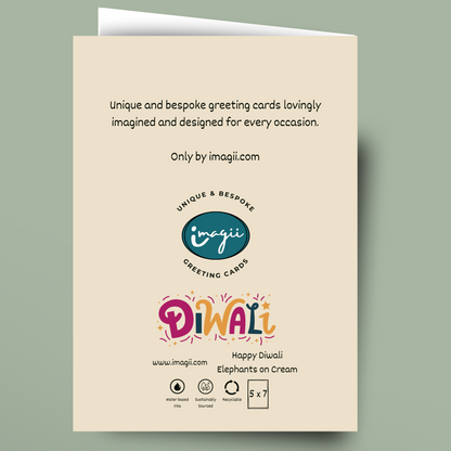 A cream-colored greeting card shown against a muted sage green background. The card features black descriptive text at the top, the 'imagii' logo in the center, and a colorful 'Diwali' title with 'Happy Diwali Elephants on Cream' at the bottom.