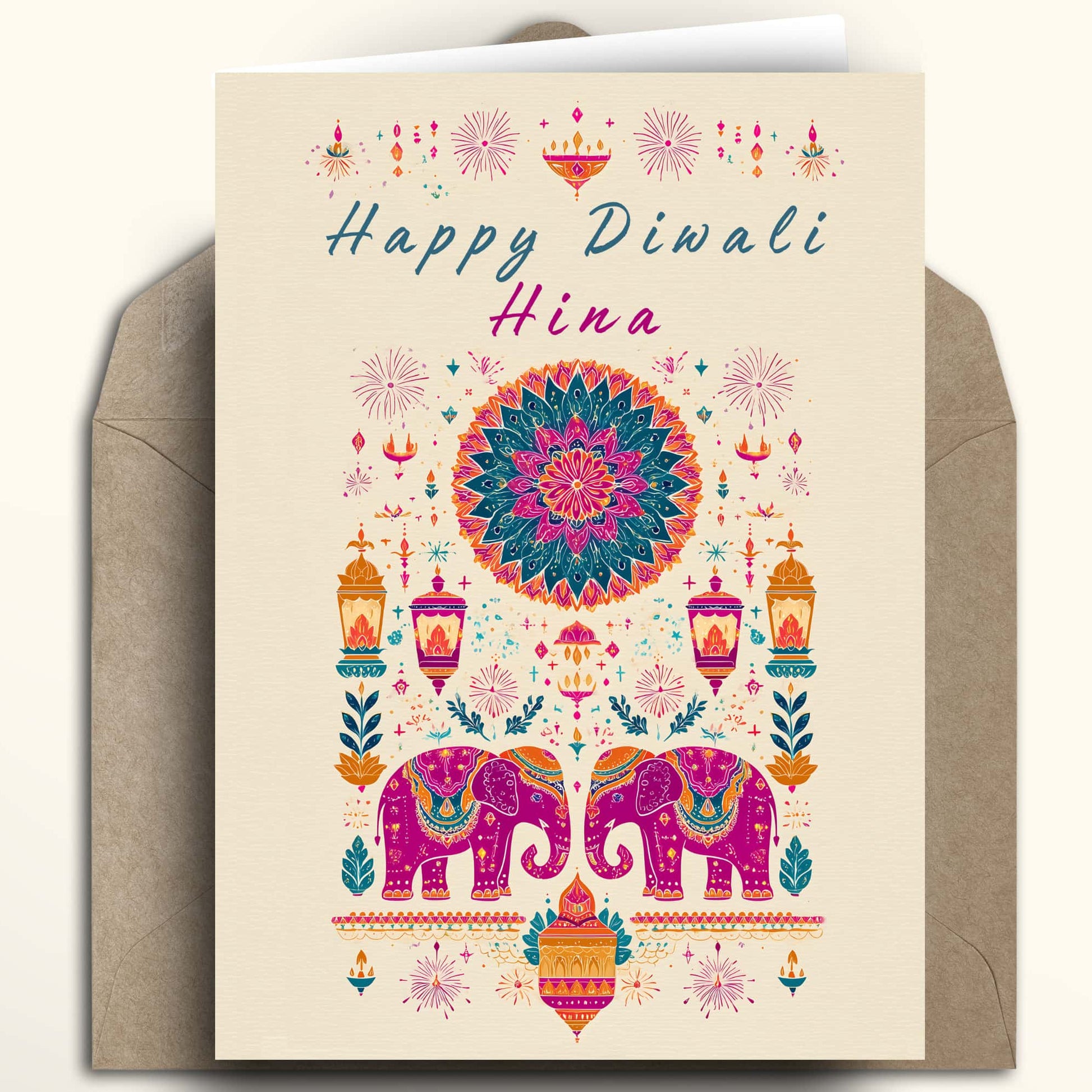 A Diwali greeting card with a cream background and colorful traditional Indian illustration, shown with a brown envelope behind it on a light beige background.