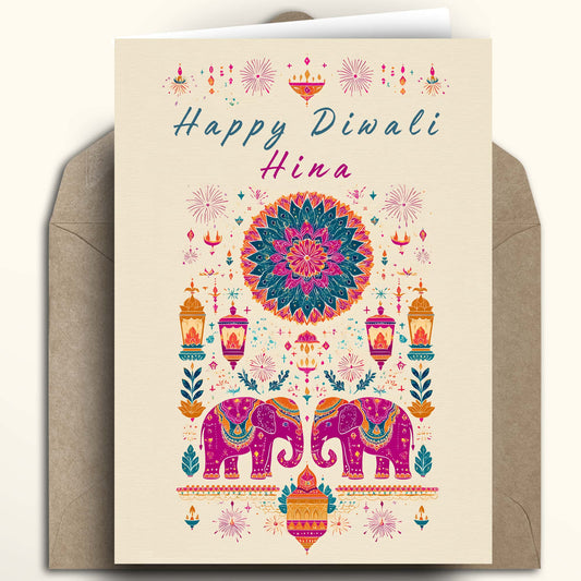 A Diwali greeting card with a cream background and colorful traditional Indian illustration, shown with a brown envelope behind it on a light beige background.