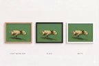 Three framed art prints showing the same dog painting in different frame finishes: light wood oak, black, and white. The prints are arranged side by side on a light background with labels underneath.