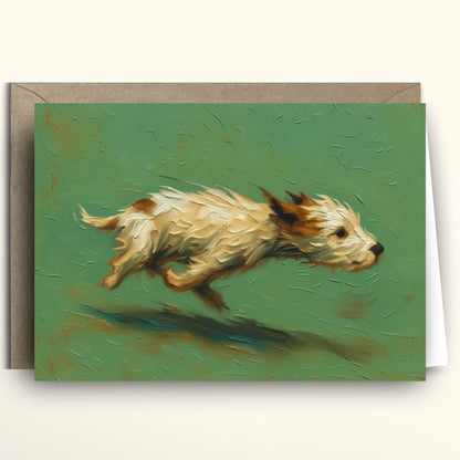 A greeting card featuring an impressionistic painting of a small cream and brown dog running across a textured green background, shown with a brown envelope behind it on a light beige surface.