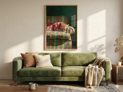 Green sofa with decorative pillows and a framed picture of a striped armchair on the wall and a framed poster of a Sleepy pink leopard resting on a retro striped green chair dark green background maximalist decor wall art