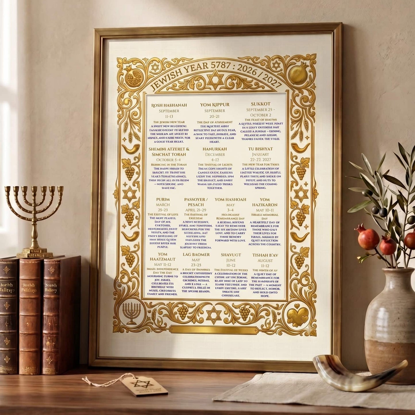 Decorative framed Jewish calendar on a wooden surface with books and a vase in the background.