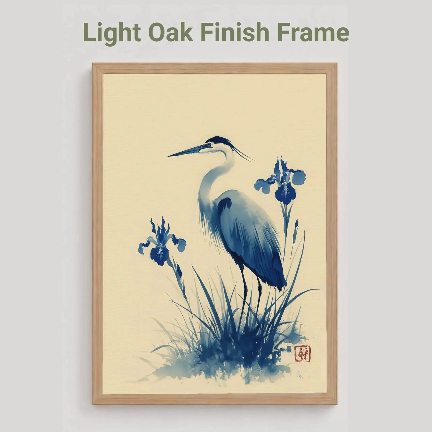light oak Framed artwork of a heron and iris flowers with a light oak finish frame on a beige background.Blue heron and water iris sumi-e print in indigo and cream — Japanese watercolour wall art with cinnabar seal
