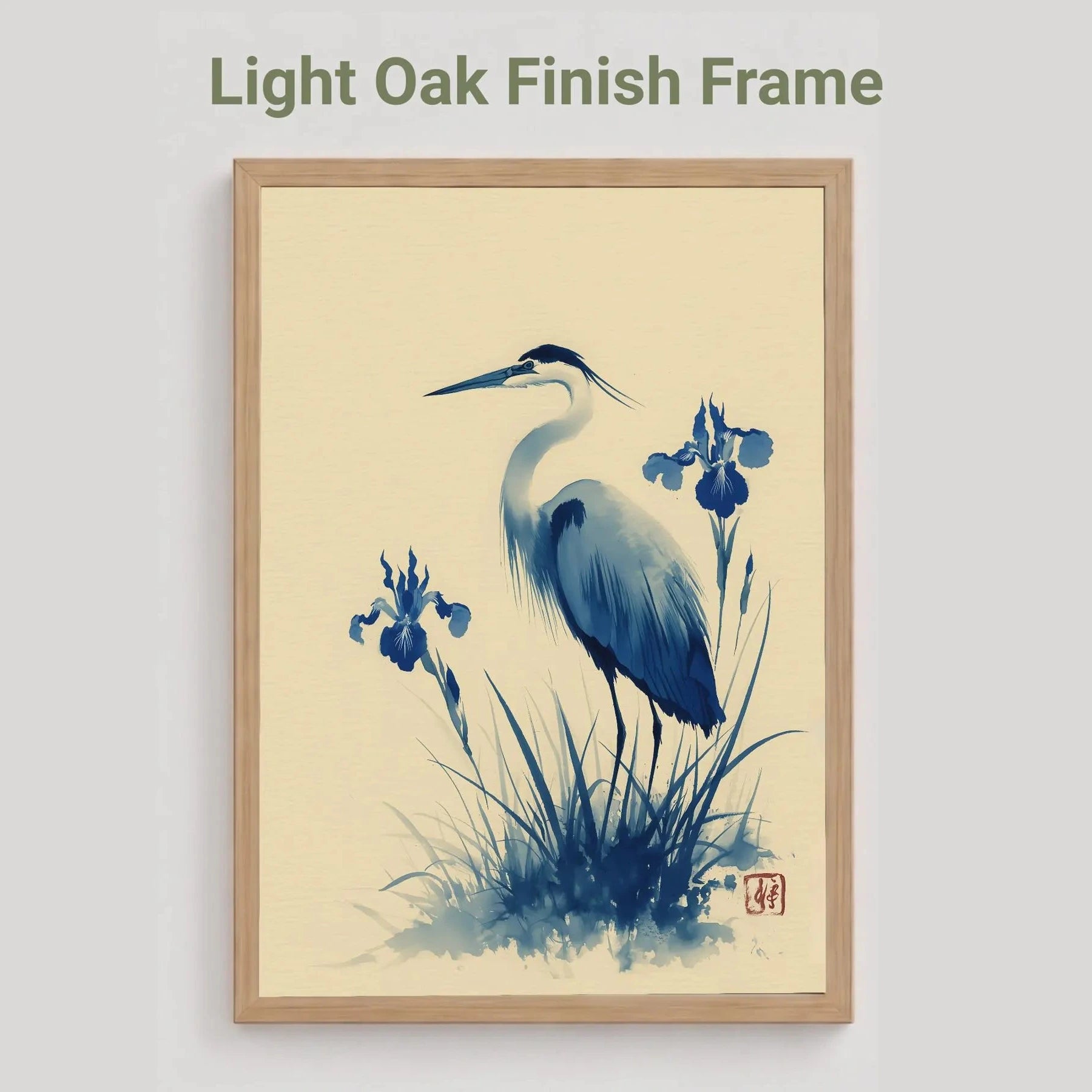 light oak Framed artwork of a heron and iris flowers with a light oak finish frame on a beige background.Blue heron and water iris sumi-e print in indigo and cream — Japanese watercolour wall art with cinnabar seal