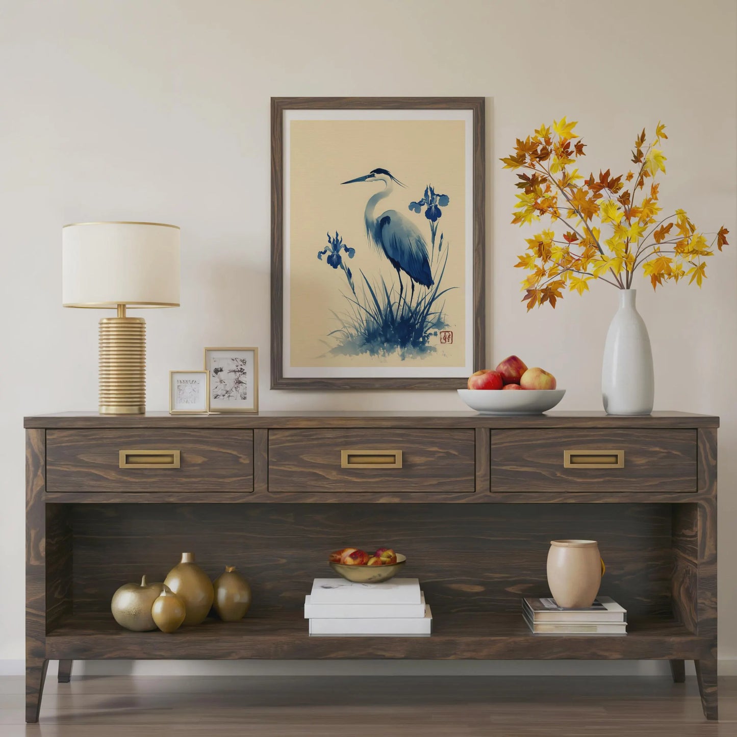 Wooden console table with decorative items including a lamp, framed art, and vases. Blue heron and water iris sumi-e print in indigo and cream — Japanese watercolour wall art with cinnabar seal