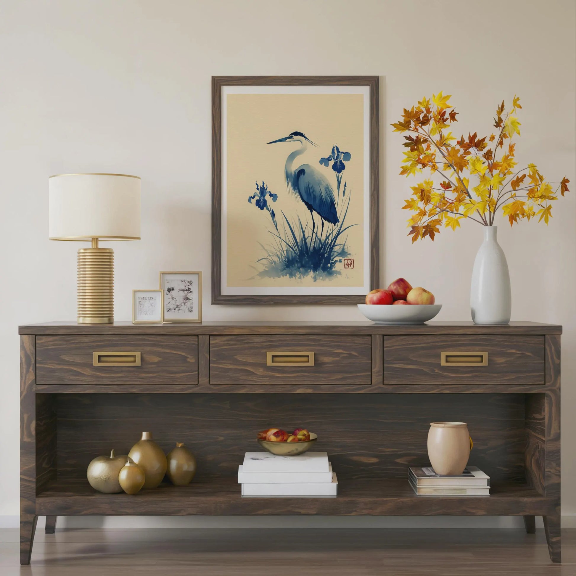 Wooden console table with decorative items including a lamp, framed art, and vases. Blue heron and water iris sumi-e print in indigo and cream — Japanese watercolour wall art with cinnabar seal