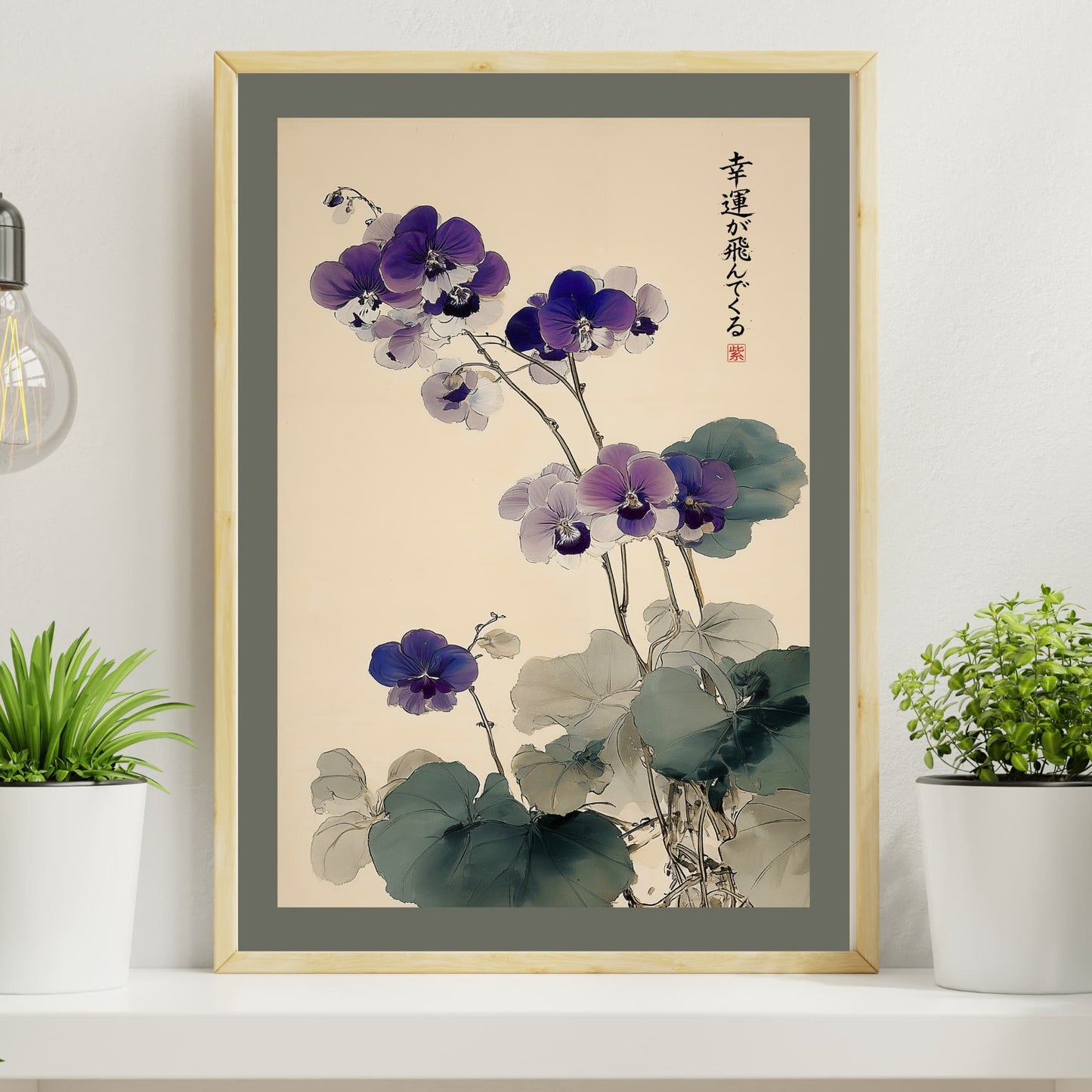 Framed artwork of a floral design on a wall with plants and a light bulb.