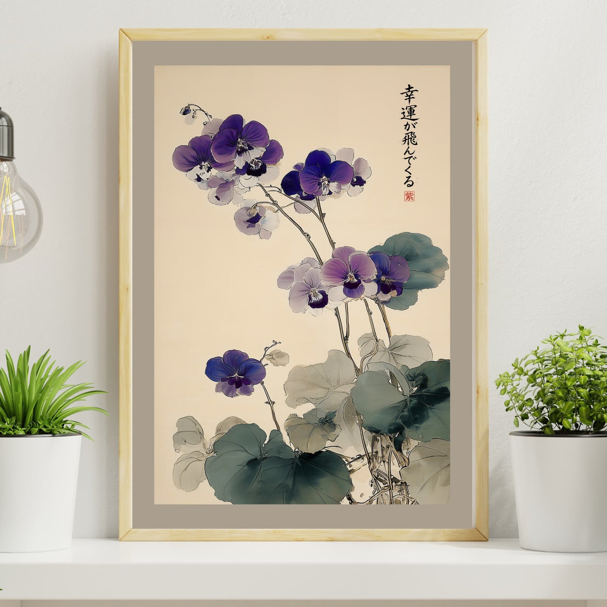 Framed artwork of purple flowers on a wall with plants and a light bulb.
