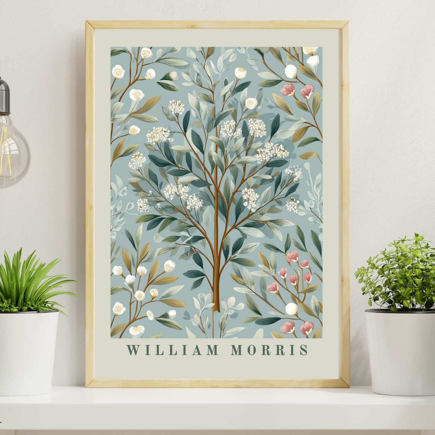 Framed artwork with floral design and 'William Morris' text, placed on a shelf with plants.