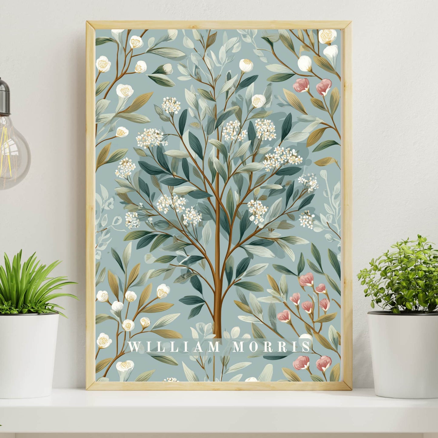 Framed botanical artwork with 'William Morris' branding on a shelf with plants.