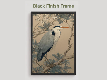 Framed artwork of a heron on a branch with leaves and flowers, black frame.