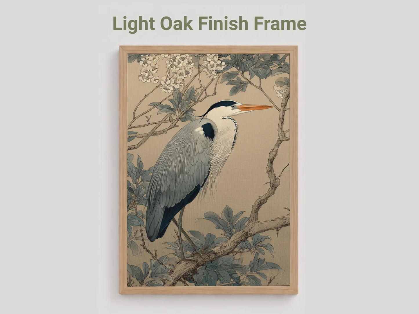 Framed artwork of a heron on a branch with light oak finish frame
