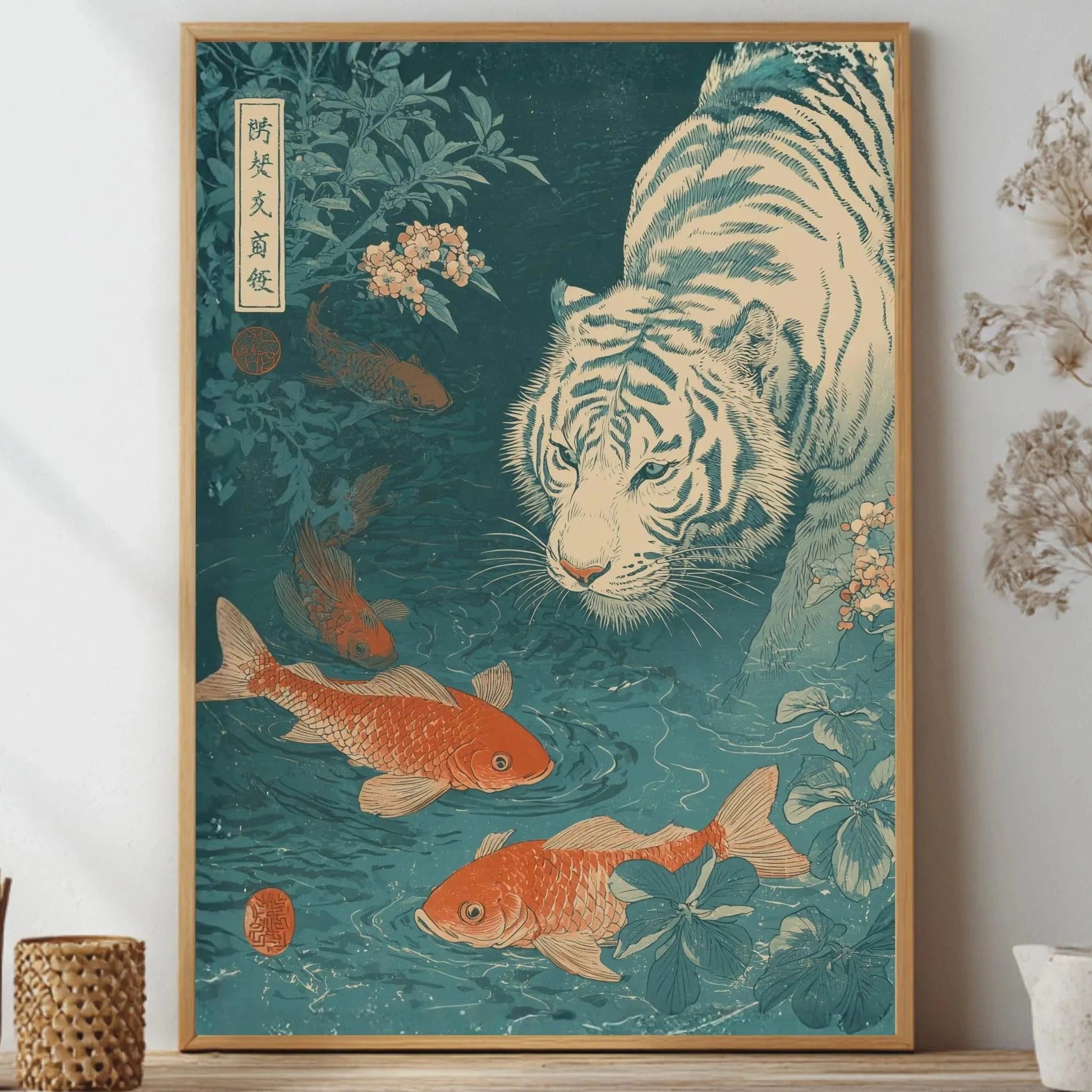 Framed artwork of a tiger and goldfish on a teal background, displayed on a wall with decorative items Japanese woodblock-style art print of a white tiger gazing into a teal koi pond, with three orange koi fish swimming in the foreground, cherry blossoms, lush foliage, and traditional Japanese calligraphy seals, in a deep teal and burnt-orange palette.