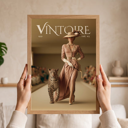 A person holds a framed art print featuring a vintage fashion magazine cover titled 'VINTOIRE 1951 vol. 03'.
