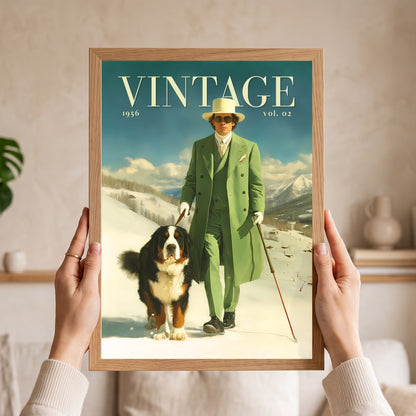 A framed vintage-style poster or print held up by two hands. The artwork shows a man in a green suit and white hat skiing in a snowy landscape, with the word "VINTAGE" at the top and a Bernese mountain dog beside him.