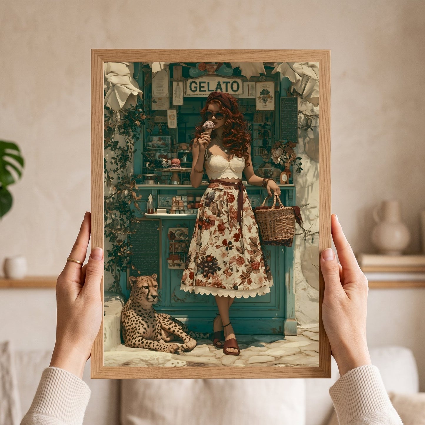 A framed art print held up by two hands in a cozy indoor setting. The print features a vintage-style illustration of a woman in a floral dress standing in front of a teal gelato shop, with a cheetah at her side. Vintage, maximalist, eclectic wall art.