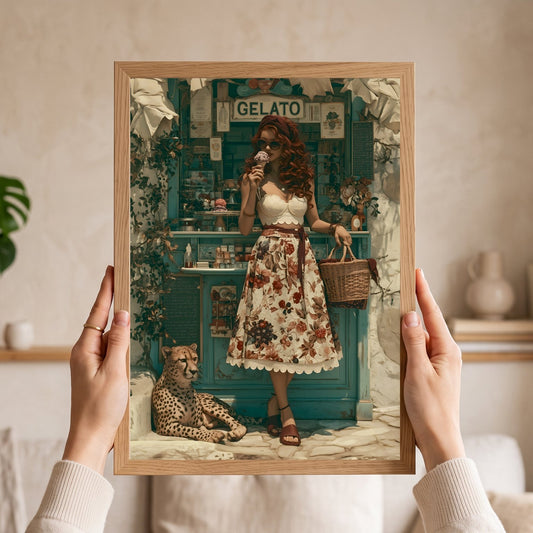 A framed art print held up by two hands in a cozy indoor setting. The print features a vintage-style illustration of a woman in a floral dress standing in front of a teal gelato shop, with a cheetah at her side. Vintage, maximalist, eclectic wall art.
