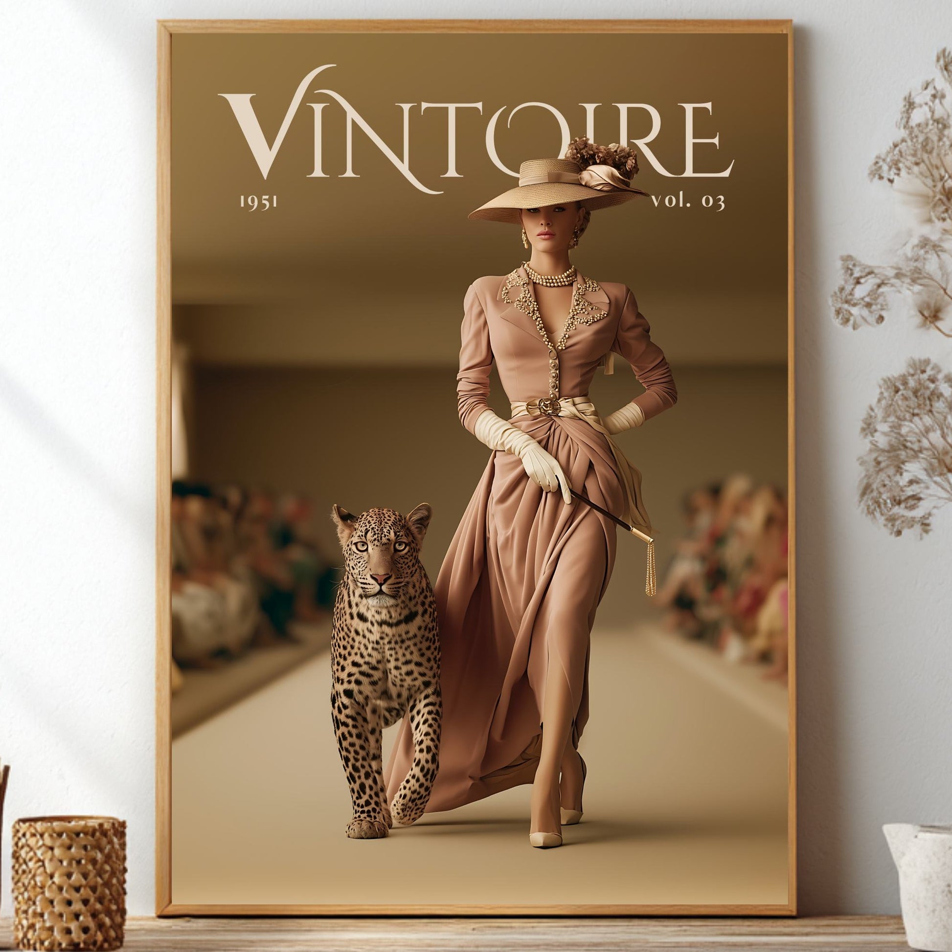A framed vintage-style fashion poster leaning against a wall on a shelf, showing a woman in a long beige dress walking beside a leopard. The poster has the title 'VINTOIRE 1951 vol.