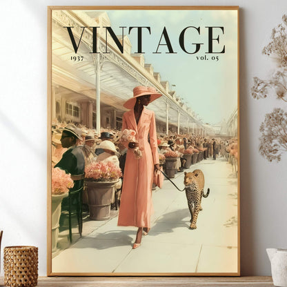 A framed vintage-style art print featuring a woman in a pink dress and hat walking a leopard on a city street, with large 'VINTAGE' text at the top. The framed print is displayed on a shelf against a light wall, surrounded by decorative dried flowers and small vases.