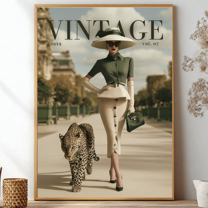 A framed vintage-style poster leaning against a wall on a shelf, surrounded by decorative dried plants and small vases. The poster shows a woman in a wide-brim hat and sunglasses walking with a leopard, with the large text 'VINTAGE 1959 vol.