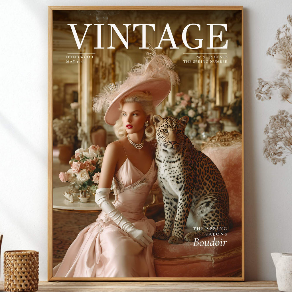 A framed vintage-style art print featuring a woman in a pale pink gown and feathered hat seated beside a leopard, styled on a shelf with dried flowers and decorative vases in a bright interior.
